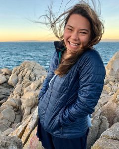 Photo of Kendra Chan standing on rocky shoreline