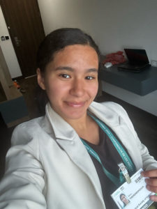 Alexa Theodoropoulos smiling and posing for a selfie while wearing a COP16 badge.