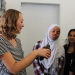 Anna Vickrey, a STEM Ambassador in the Biology Department, takes students in the Center for Science and Math Education’s REFUGES Bridge Program on a lab tour. Photo courtesy of Caitlin Weber.