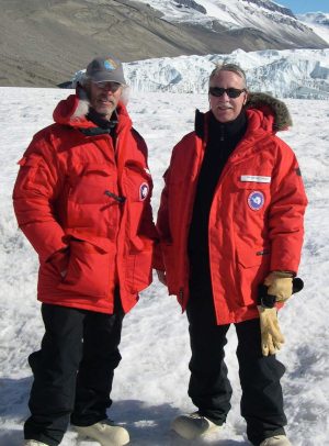 Two men pose for a profile picture in the snow.