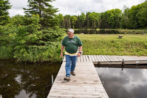 Gary Belovsky walks down a dock.